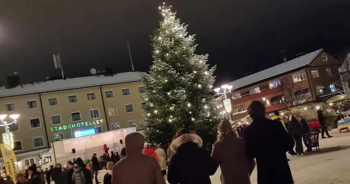 Folk runt julgran på torget.